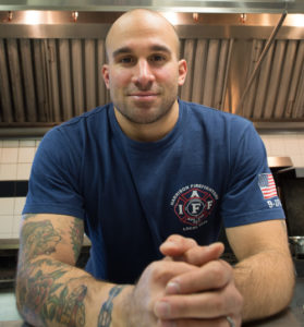 A.J. Fusco, a Harrison firefighter, will compete on the Food Network’s popular television show, “Guy’s Grocery Games,” hosted by Guy Fieri, airing on Aug. 14. Photo courtesy ForkandHoseCO.com