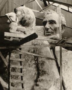 In an undated photo, Luigi Del Bianco stands on a scaffold next to the model of Lincoln’s head used to recreate the mountainside Rushmore version. 