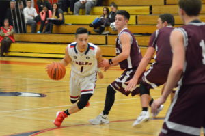 Benny DiMirco drives into the lane against Harrison. DiMirco had 20 points in the Eastchester win. Photo/Mike Smith