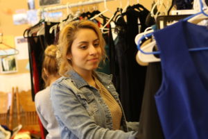 Daisy Gutierrez looks at potential prom dresses available at The Prom Collective. Photos/Andrew Dapolite
